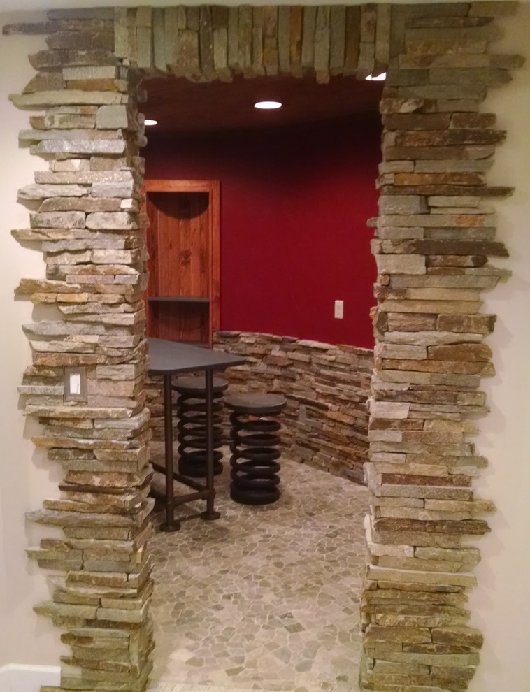 Inspiration for a medium sized industrial wine cellar in Indianapolis with limestone flooring and display racks.