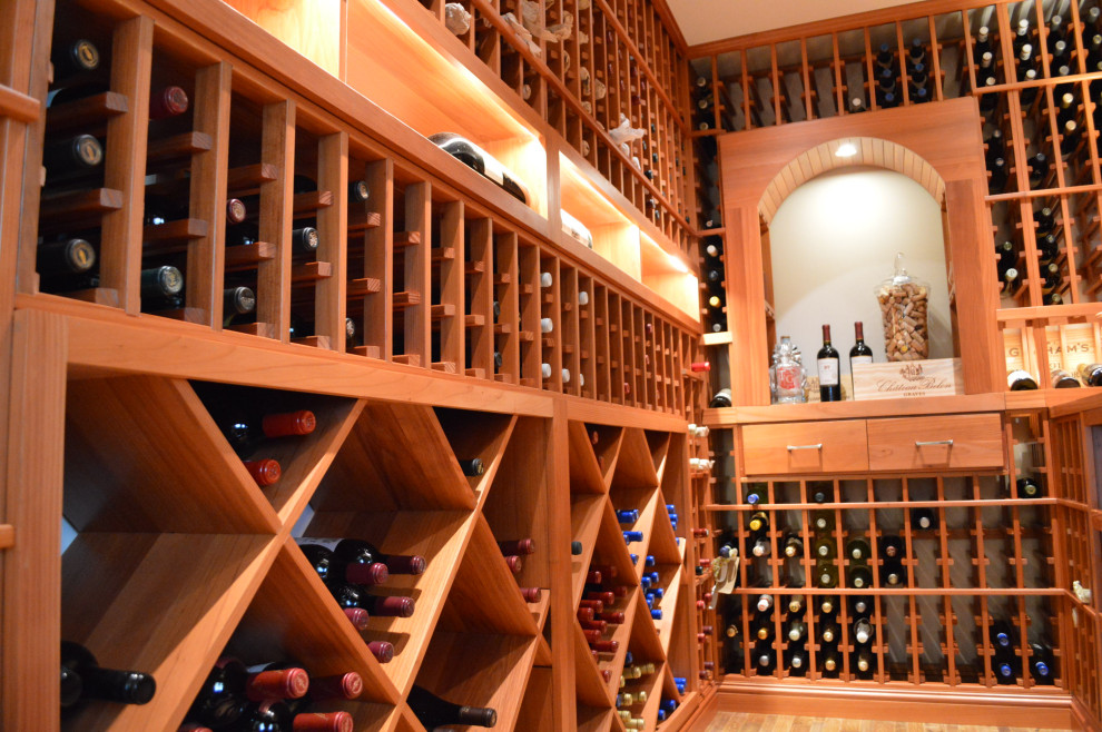 Inspiration for a mid-sized timeless medium tone wood floor wine cellar remodel with storage racks