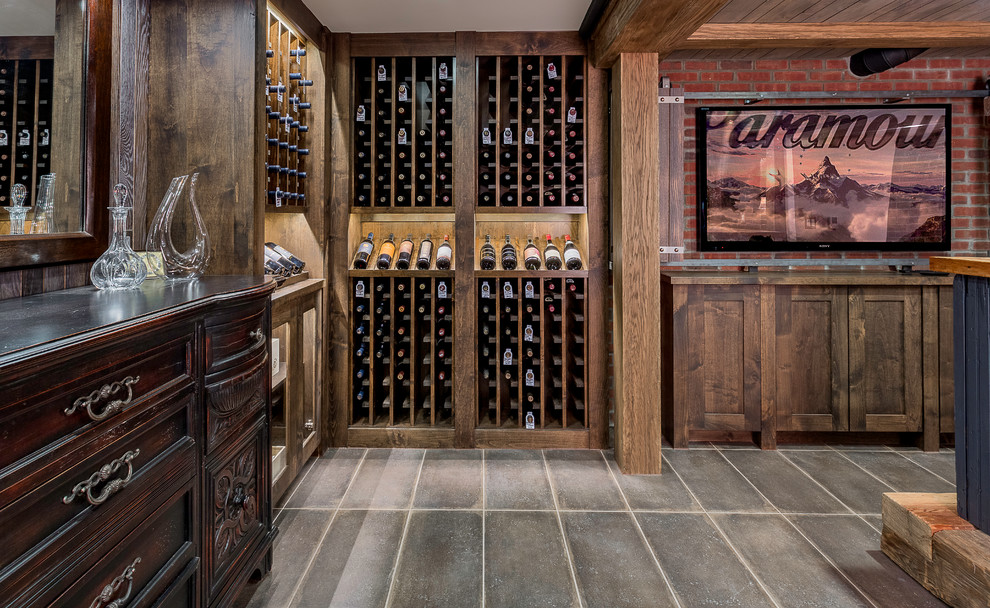 Wine cellar - large rustic ceramic tile and gray floor wine cellar idea in Detroit with storage racks
