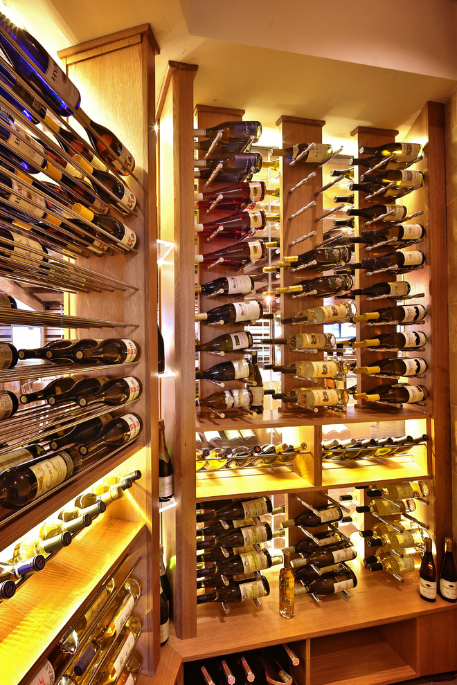 Medium sized scandi wine cellar in San Francisco with display racks.
