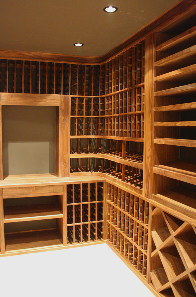 Example of a mid-sized classic medium tone wood floor wine cellar design in Los Angeles with storage racks