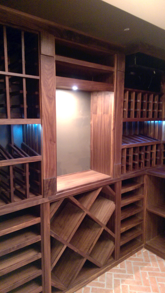 Wine cellar - mid-sized traditional medium tone wood floor wine cellar idea in Los Angeles with storage racks
