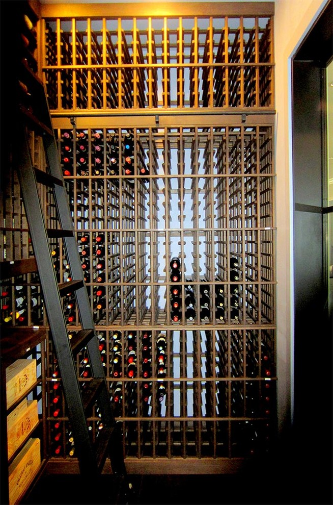 Inspiration for a medium sized classic wine cellar in Dallas with storage racks, brown floors and dark hardwood flooring.