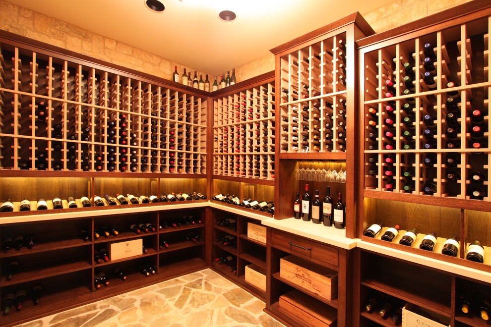 Inspiration for a medium sized wine cellar in Houston with travertine flooring, storage racks and beige floors.