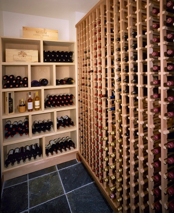 This is an example of a large contemporary wine cellar in Orange County with storage racks.