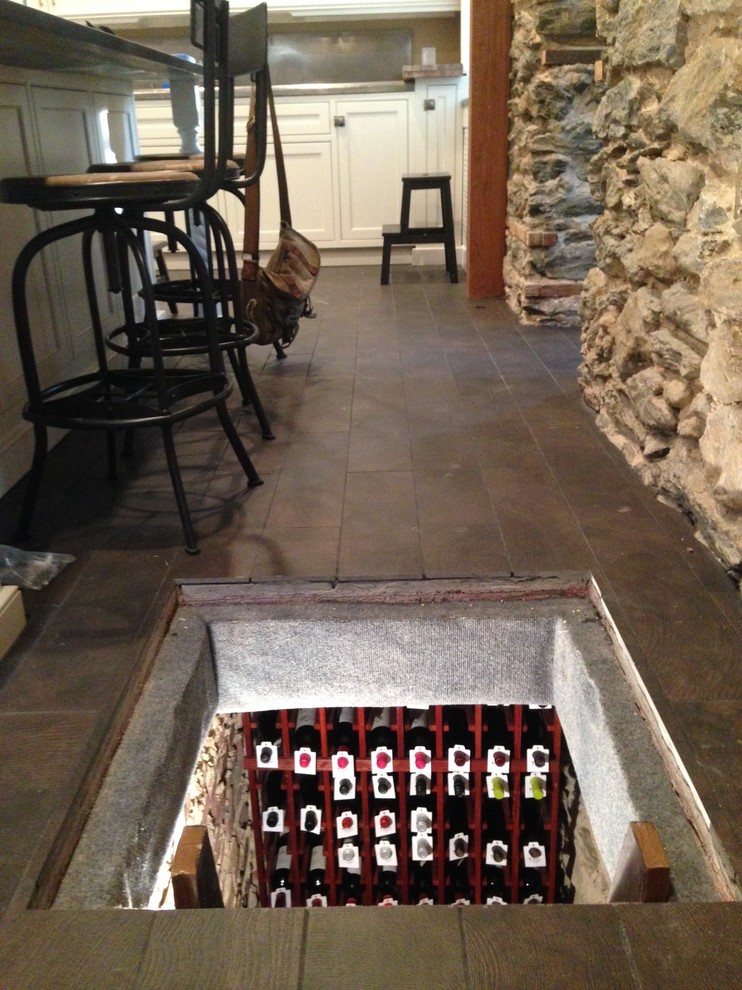 Wine cellar - mid-sized transitional dark wood floor wine cellar idea in Philadelphia with storage racks