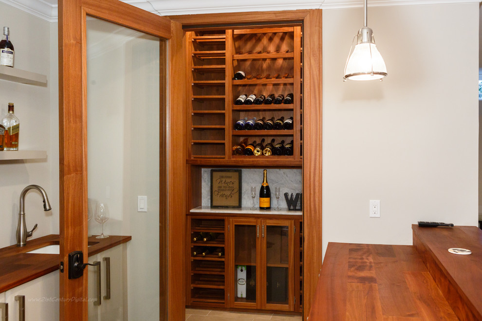 Example of a mid-sized minimalist porcelain tile wine cellar design in New York with display racks
