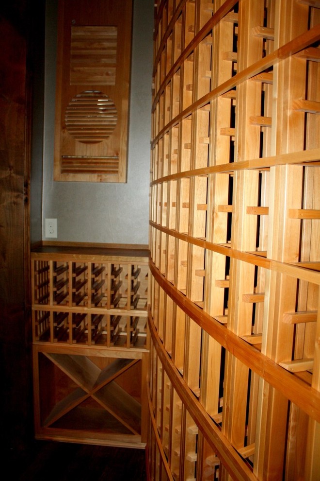 This is an example of a small traditional wine cellar in Dallas with storage racks.