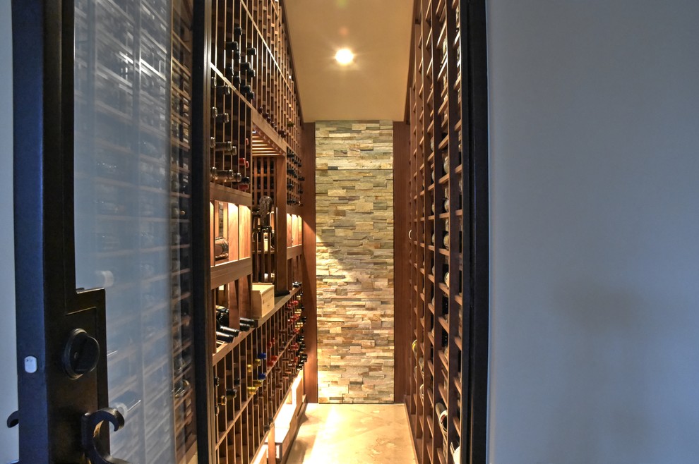 Photo of a medium sized beach style wine cellar in San Diego with marble flooring and display racks.