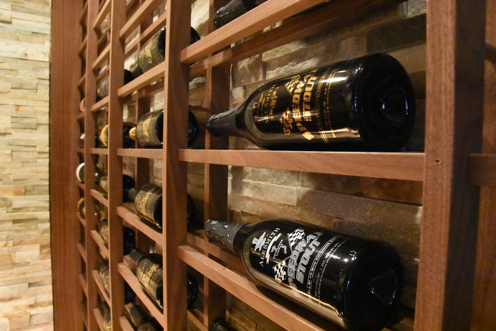 Example of a mid-sized cottage chic marble floor wine cellar design in San Diego with display racks