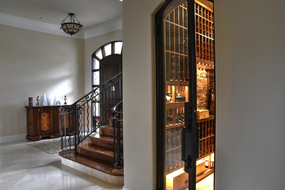 Inspiration for a medium sized mediterranean wine cellar in San Diego with marble flooring and display racks.