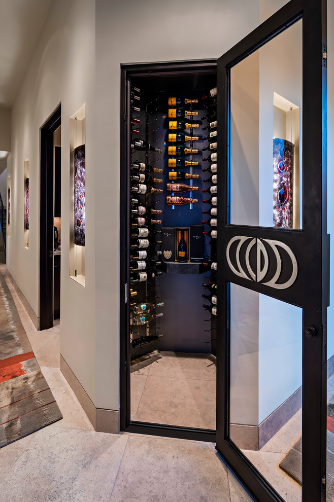 This is an example of a small contemporary wine cellar in Phoenix with storage racks.