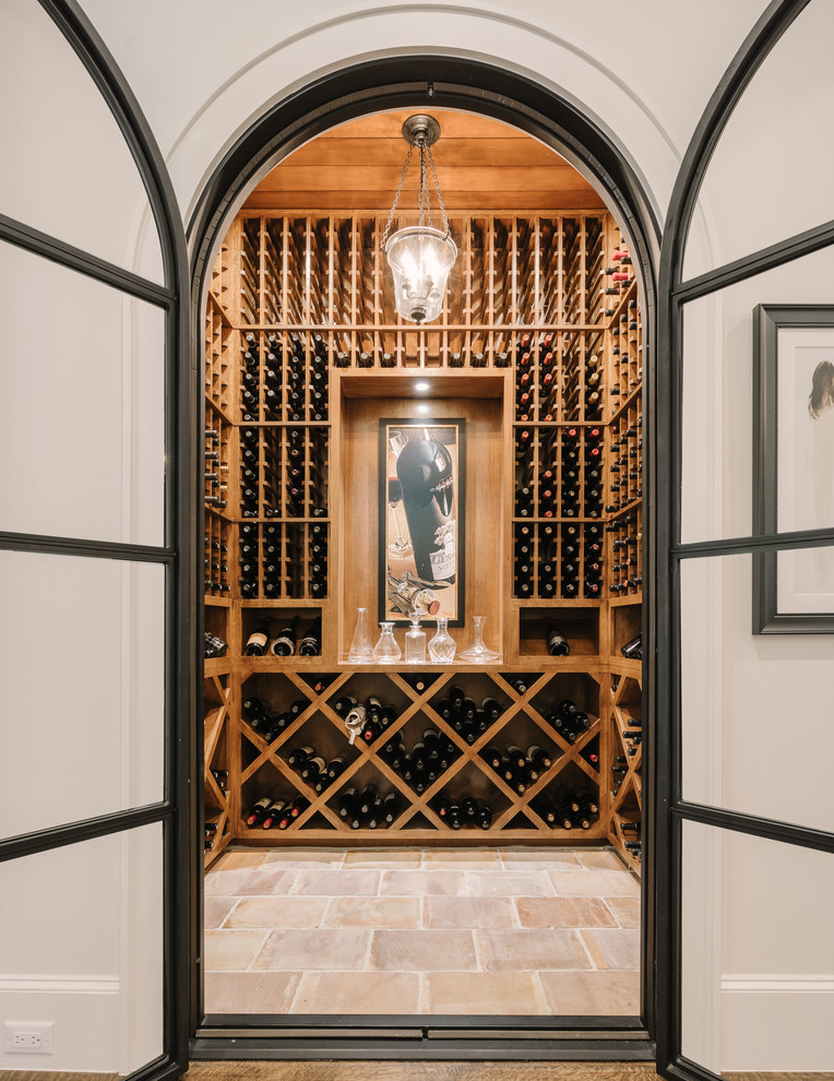 Design ideas for a traditional wine cellar in Dallas with cube storage and beige floors.