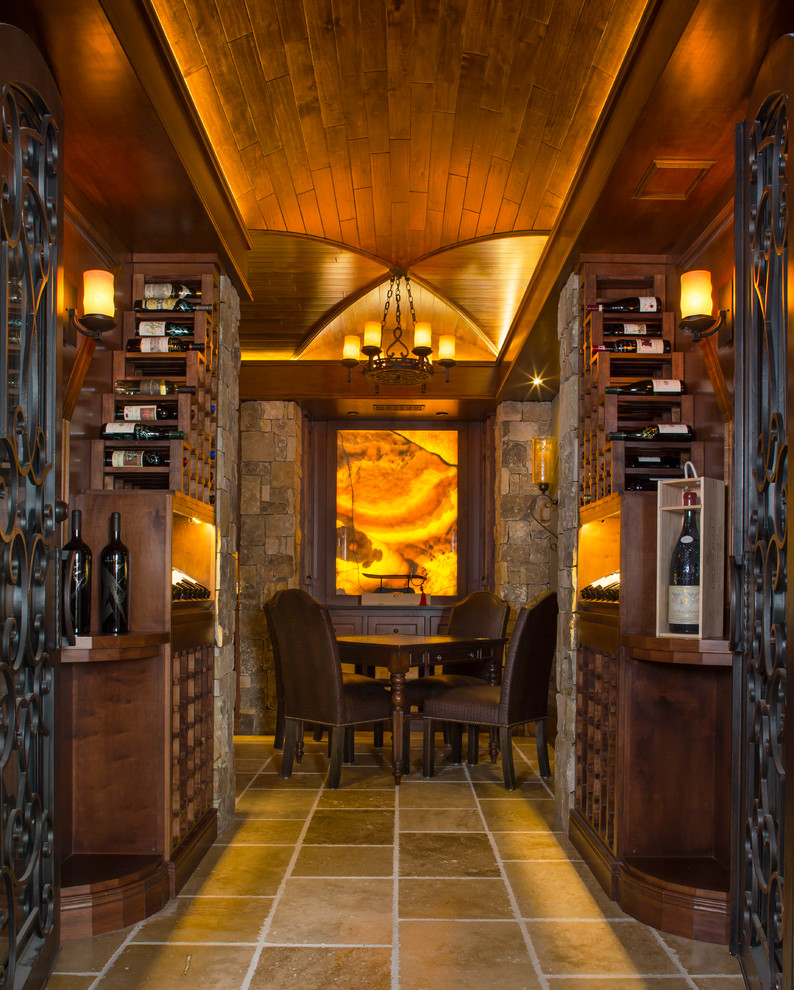 Example of a mid-sized classic travertine floor wine cellar design in Atlanta with display racks
