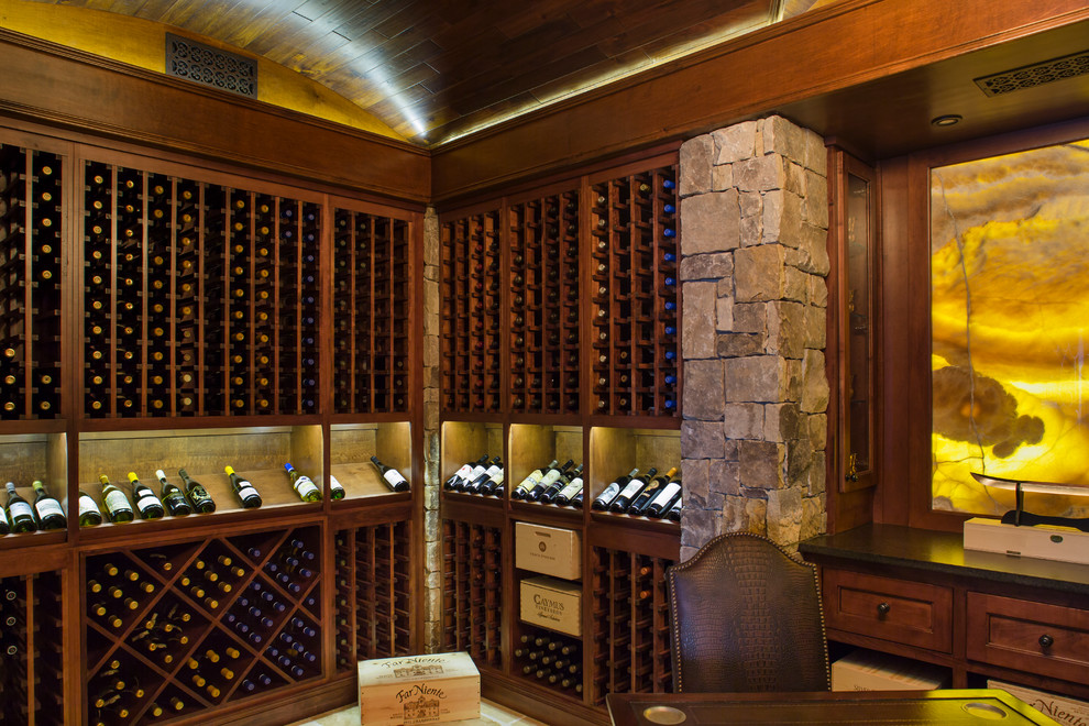 This is an example of a medium sized traditional wine cellar in Atlanta with travertine flooring and display racks.