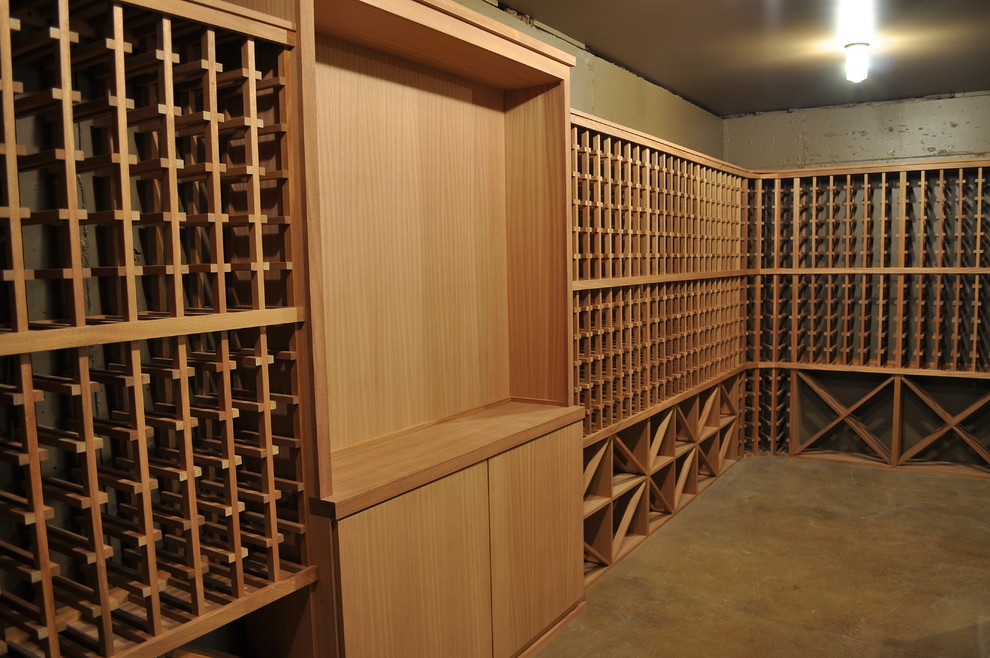 Aménagement d'une cave à vin classique de taille moyenne avec sol en béton ciré, un présentoir et un sol marron.