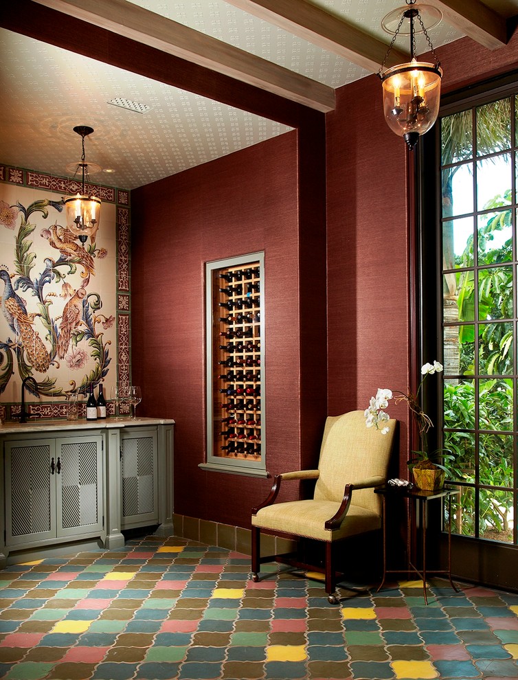 This is an example of a world-inspired wine cellar in Miami with storage racks and multi-coloured floors.
