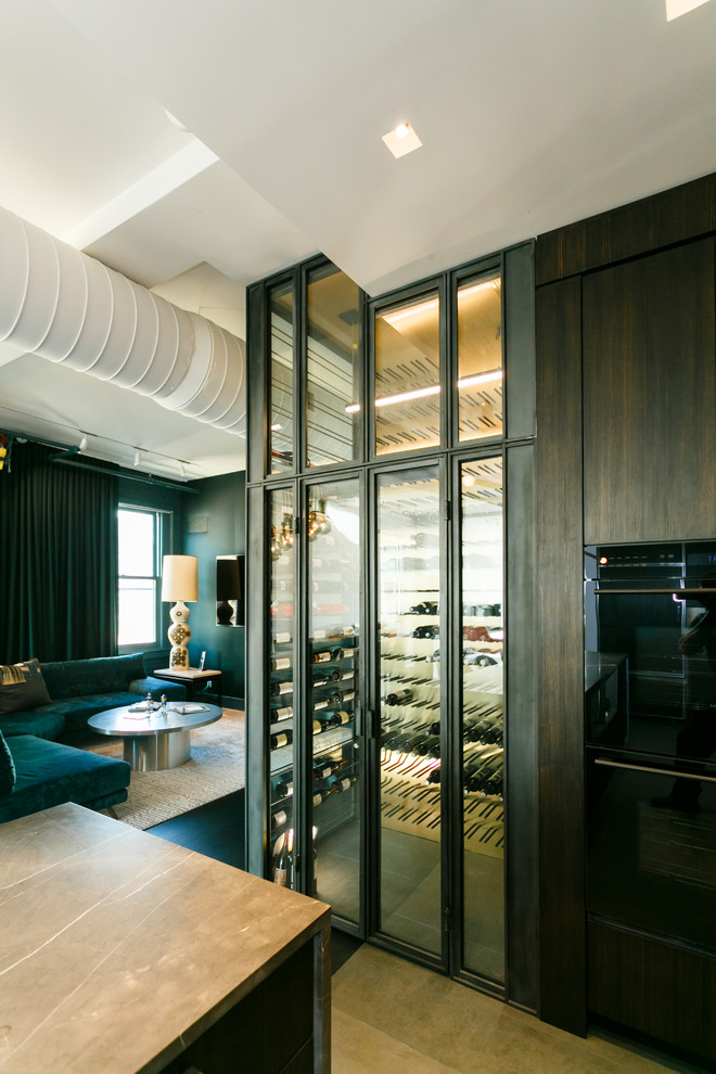 Example of a mid-sized minimalist slate floor wine cellar design in New York with display racks