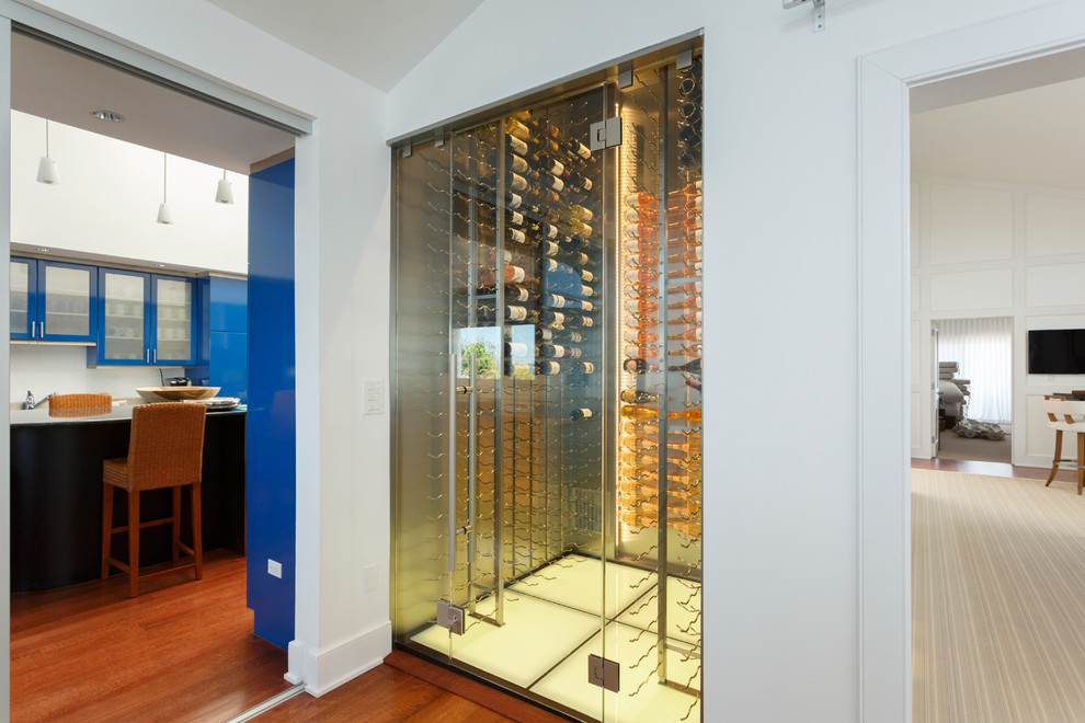 Medium sized contemporary wine cellar in New York with marble flooring and display racks.