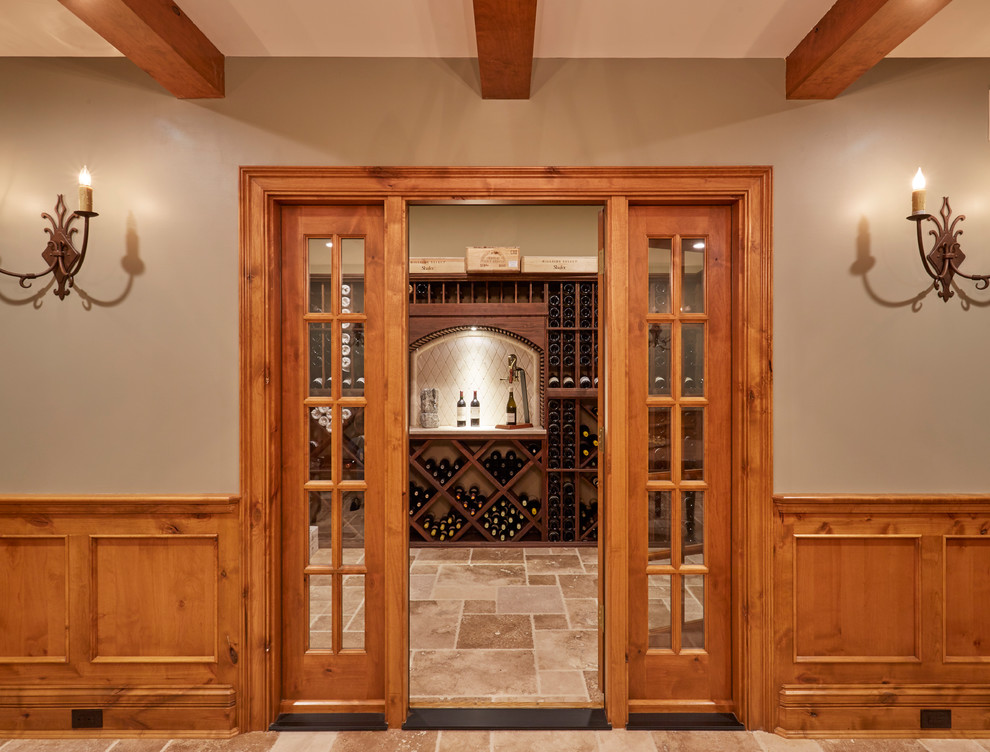 Example of a mid-sized classic limestone floor and brown floor wine cellar design in Milwaukee with diamond bins