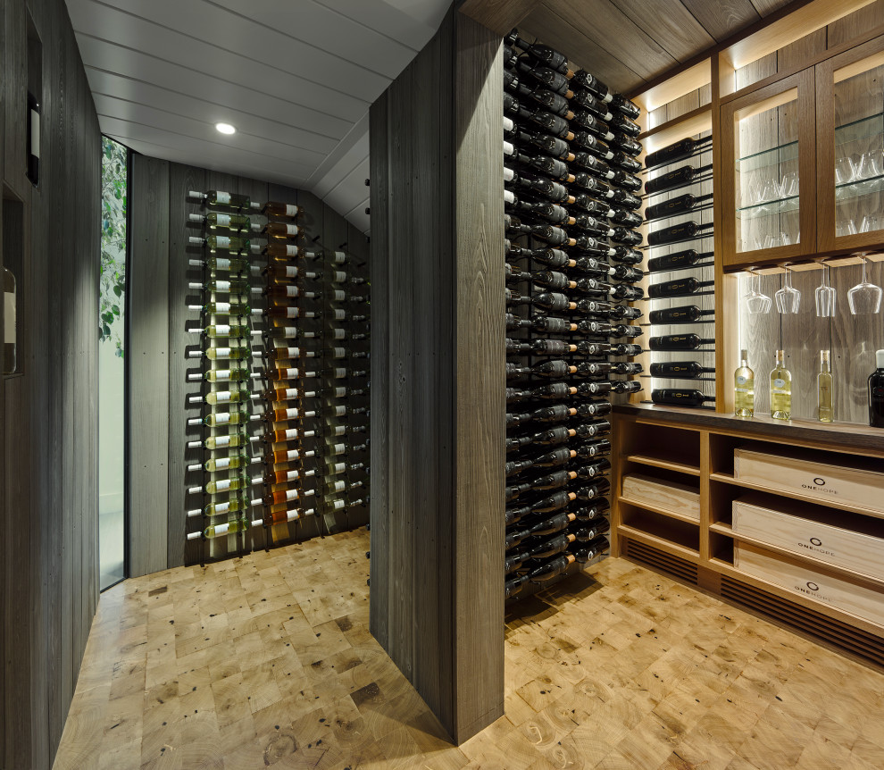 Example of a huge trendy beige floor wine cellar design in San Francisco with display racks