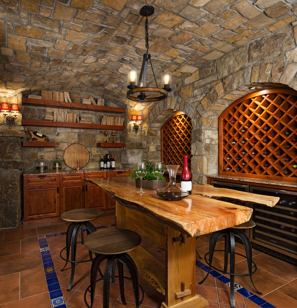 Wine cellar - mediterranean terra-cotta tile and brown floor wine cellar idea in Detroit