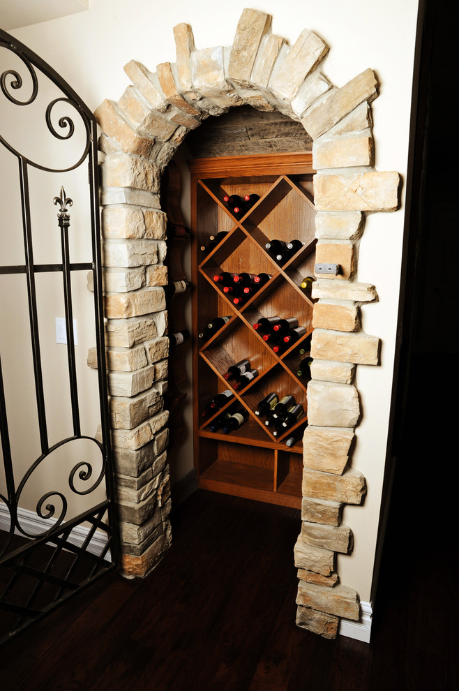 Wine cellar - small mediterranean dark wood floor wine cellar idea in Other with diamond bins