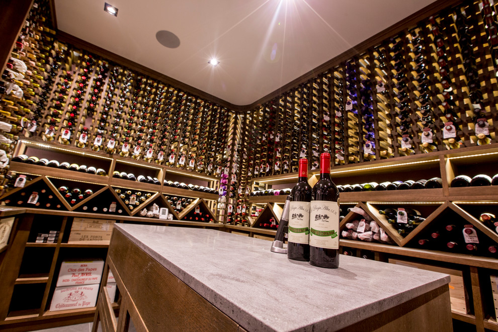 Photo of a medium sized contemporary wine cellar in London with display racks.