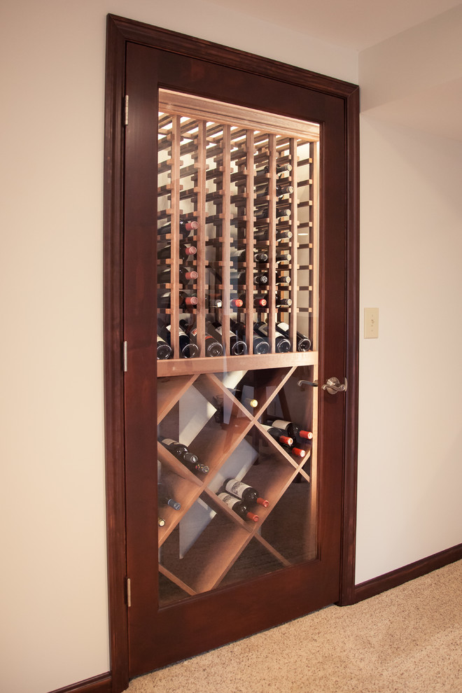 Inspiration for a mid-sized timeless carpeted wine cellar remodel in Cincinnati with display racks
