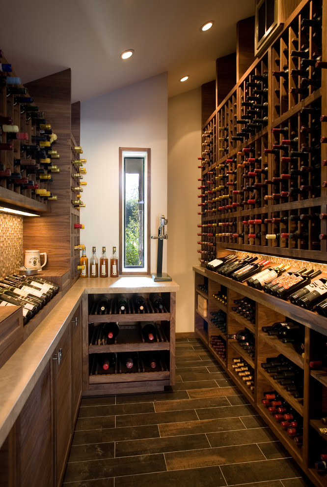 Trendy brown floor wine cellar photo in Santa Barbara with storage racks