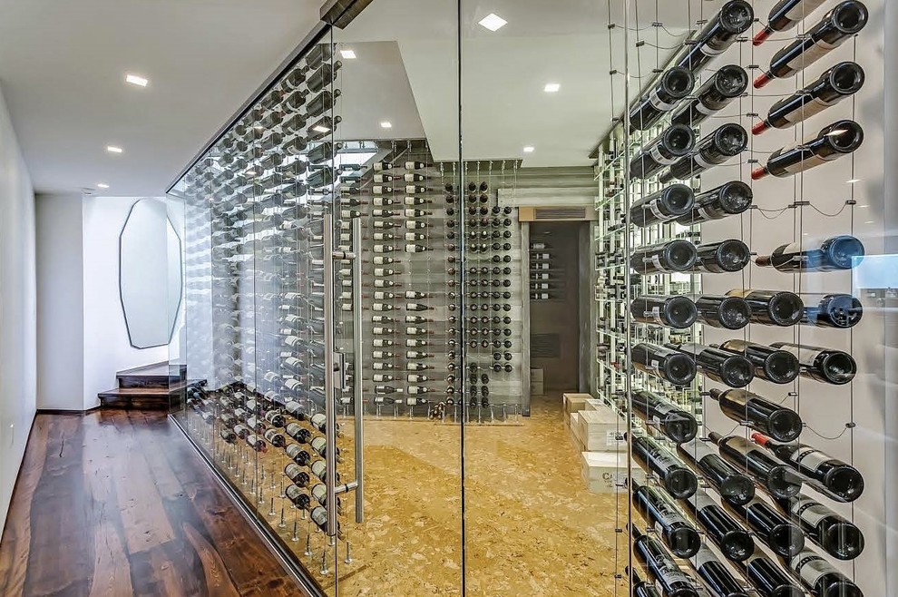 Inspiration for a large contemporary yellow floor wine cellar remodel in Toronto with storage racks