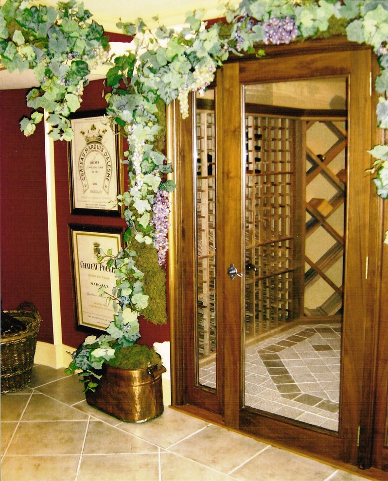 Example of a huge tuscan travertine floor wine cellar design in Las Vegas with diamond bins