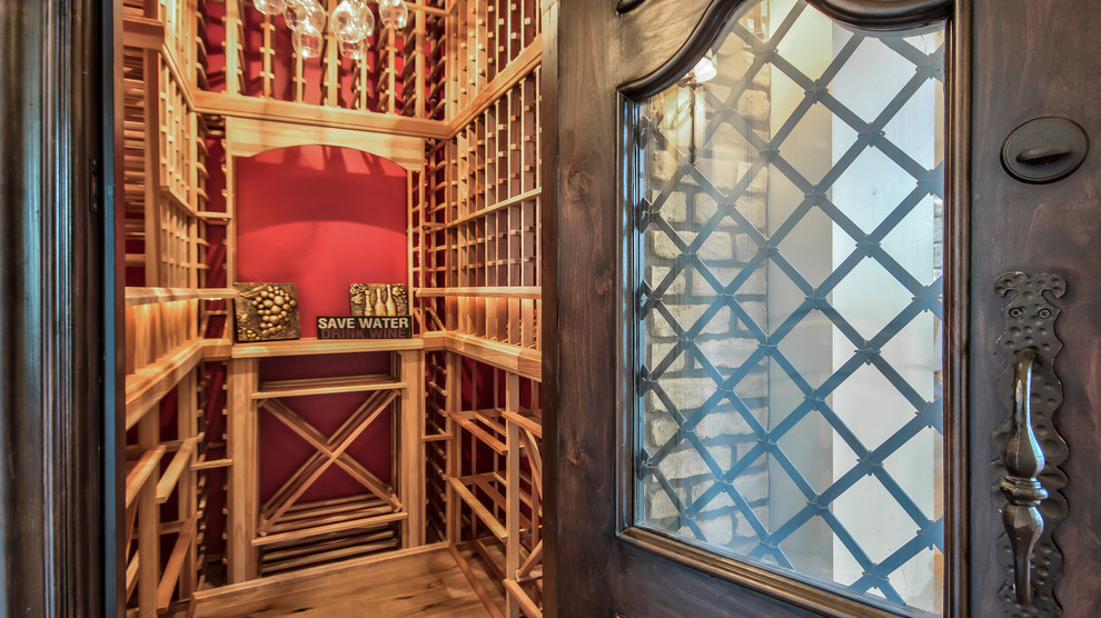 Design ideas for a medium sized country wine cellar in Phoenix with light hardwood flooring and display racks.