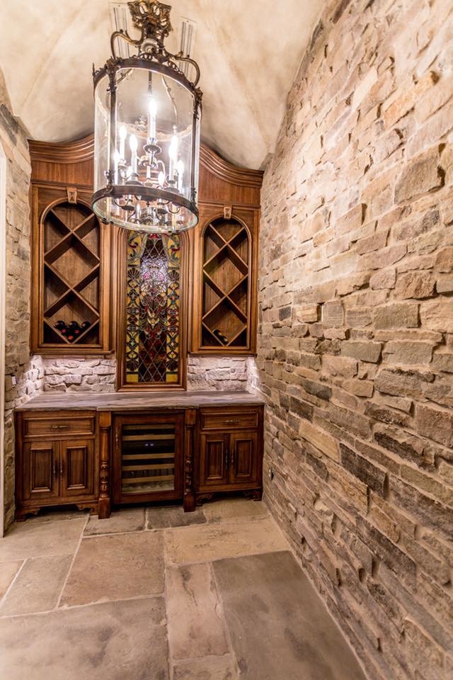 Photo of a small traditional wine cellar in New Orleans with slate flooring, cube storage and grey floors.