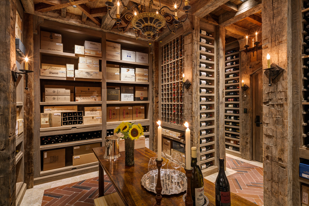 Elegant ceramic tile and red floor wine cellar photo in New York with storage racks