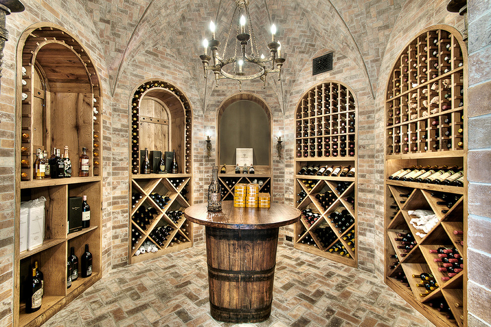 Classic wine cellar in Houston with brick flooring.