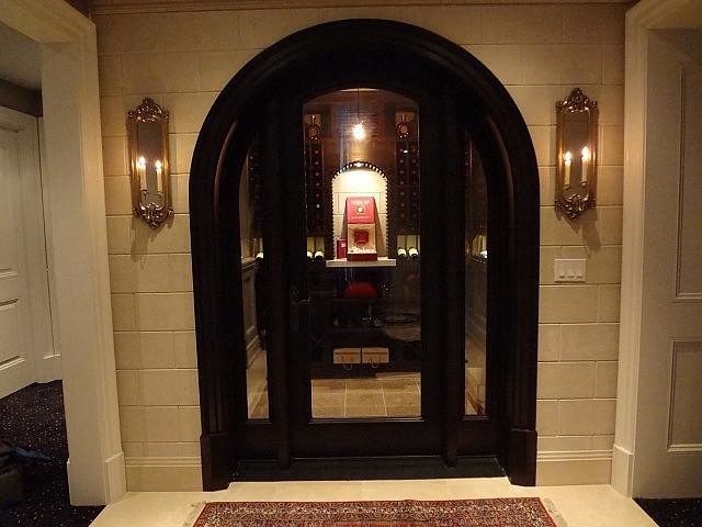 Example of a mid-sized ornate beige floor and limestone floor wine cellar design in Toronto with diamond bins