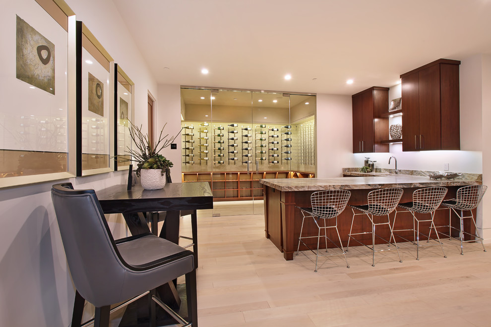 Large contemporary wine cellar in Orange County with light hardwood flooring, display racks and brown floors.