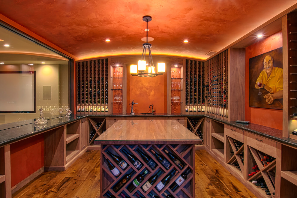 Inspiration for a mid-sized mediterranean medium tone wood floor wine cellar remodel in Orange County