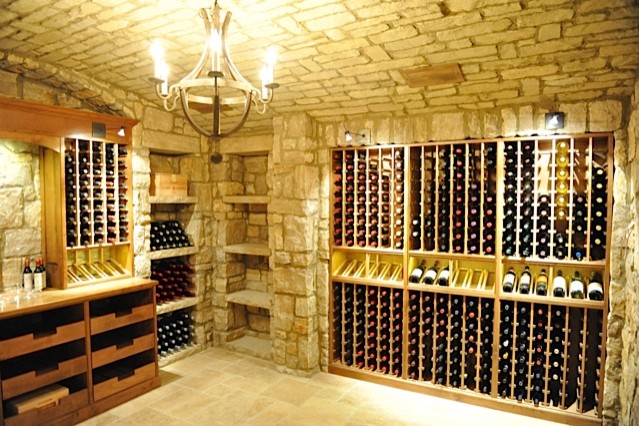 Inspiration for a mid-sized shabby-chic style ceramic tile wine cellar remodel in Los Angeles with display racks