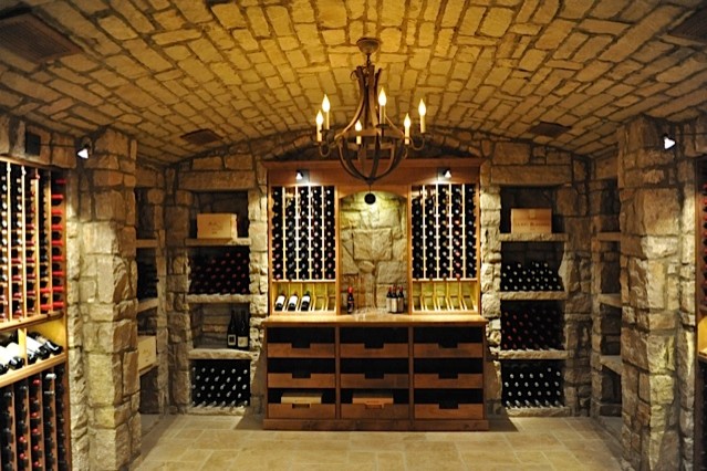 This is an example of a medium sized eclectic wine cellar in Los Angeles with ceramic flooring and storage racks.