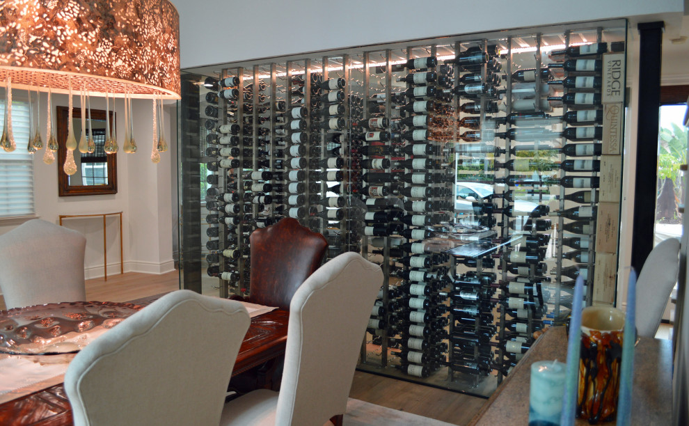 GlassEnclosed Wine Cellar Matches the Elegant Dining Room in a home in