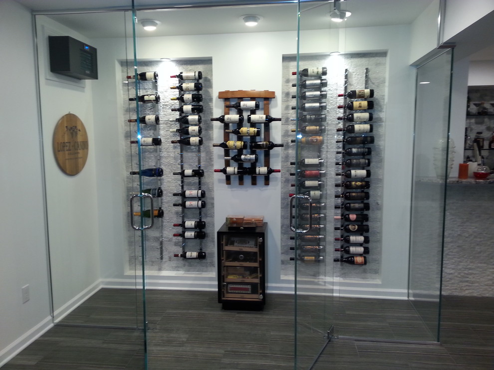Mid-sized minimalist porcelain tile and gray floor wine cellar photo in New York with display racks