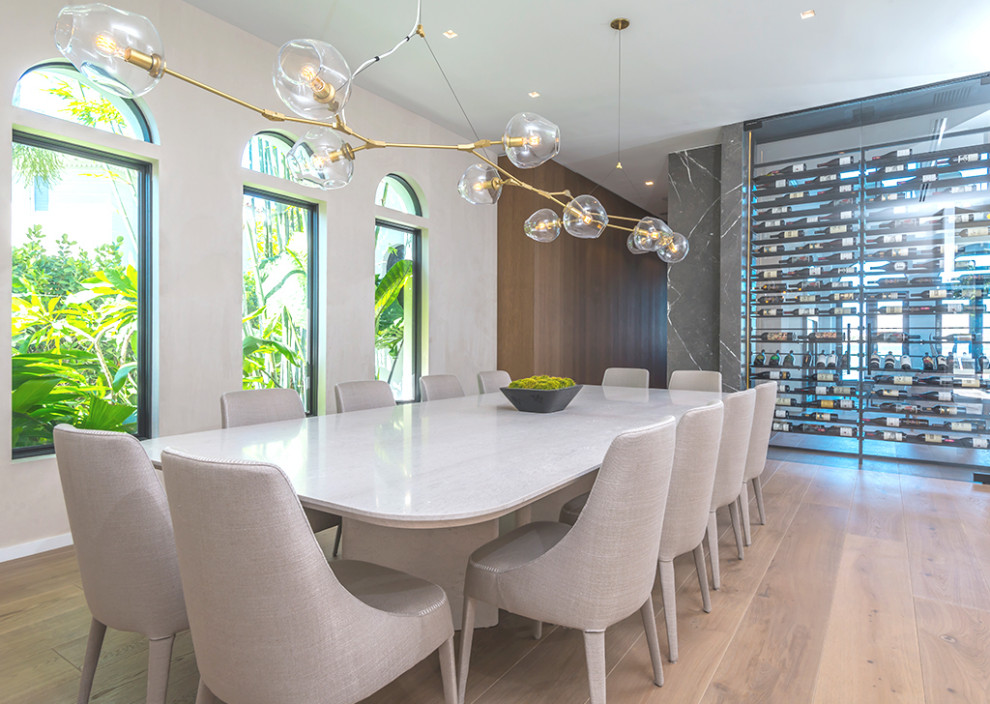 Inspiration for a large contemporary medium tone wood floor and brown floor dining room remodel in Miami