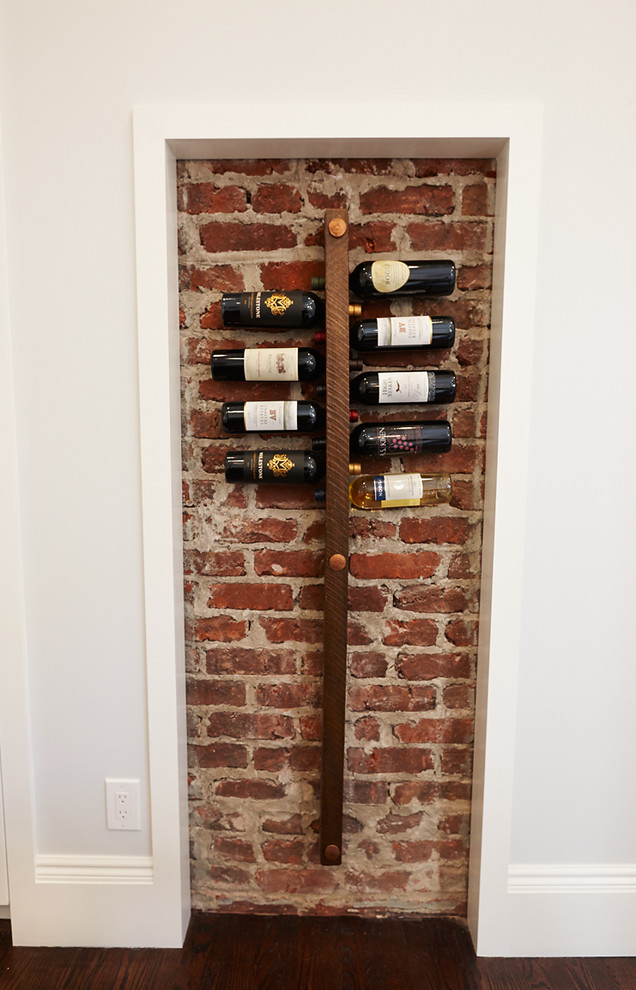 Inspiration for a mid-sized timeless dark wood floor wine cellar remodel in San Francisco with display racks