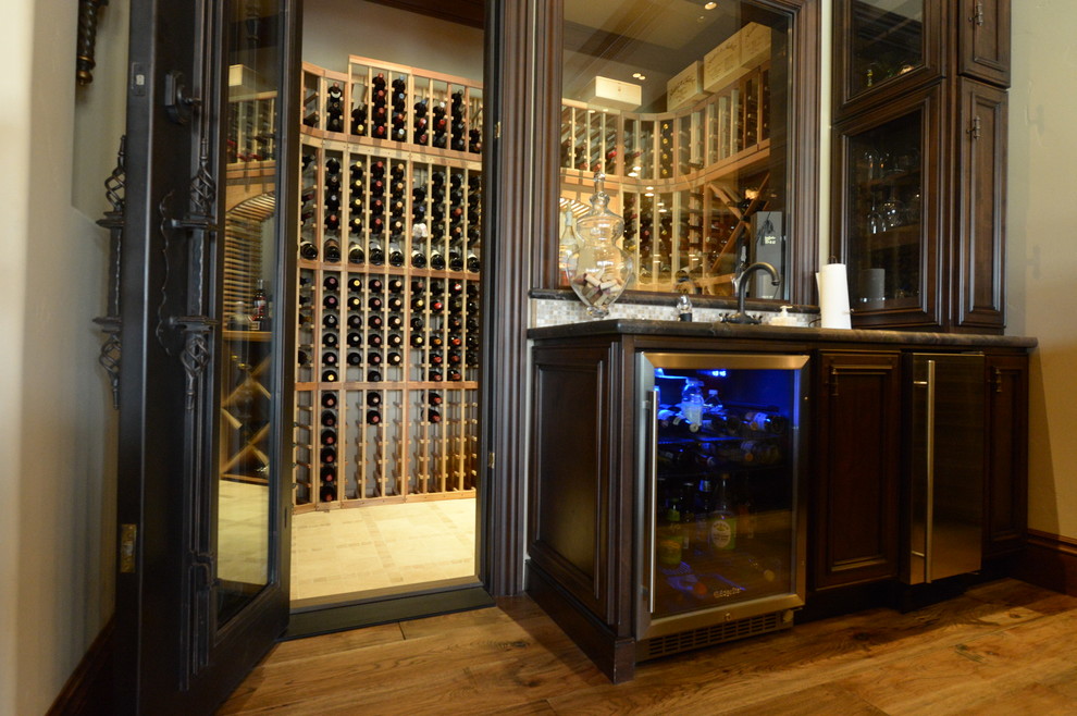Medium sized classic wine cellar in San Francisco with medium hardwood flooring and storage racks.