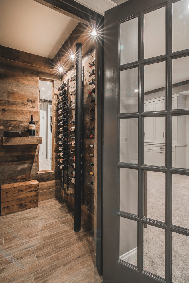 Wine cellar - small rustic ceramic tile wine cellar idea in Columbus with storage racks