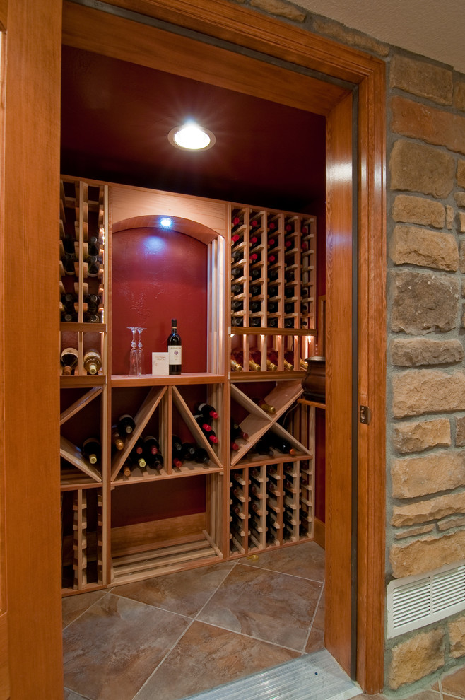 Inspiration for an expansive rustic wine cellar in Denver with carpet and cube storage.