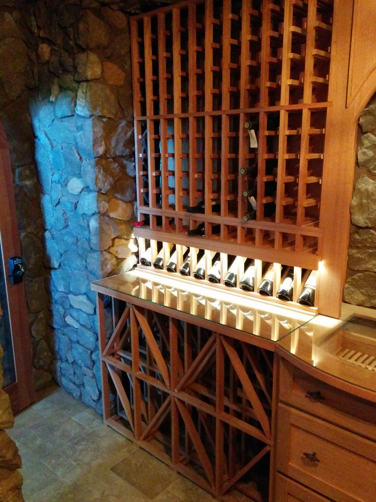 Inspiration for a medium sized classic wine cellar in Calgary with porcelain flooring and display racks.