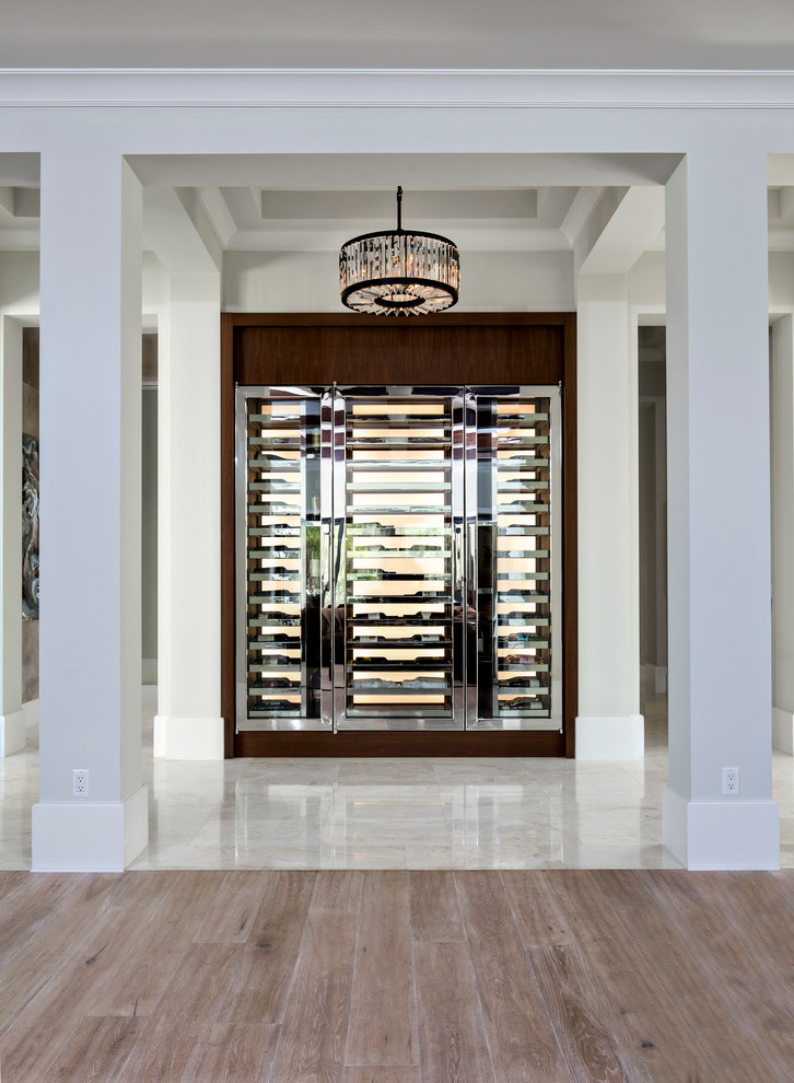 Inspiration for a large contemporary marble floor wine cellar remodel in Miami with display racks